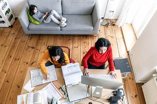 a mom and two girls working in a New York City appartment